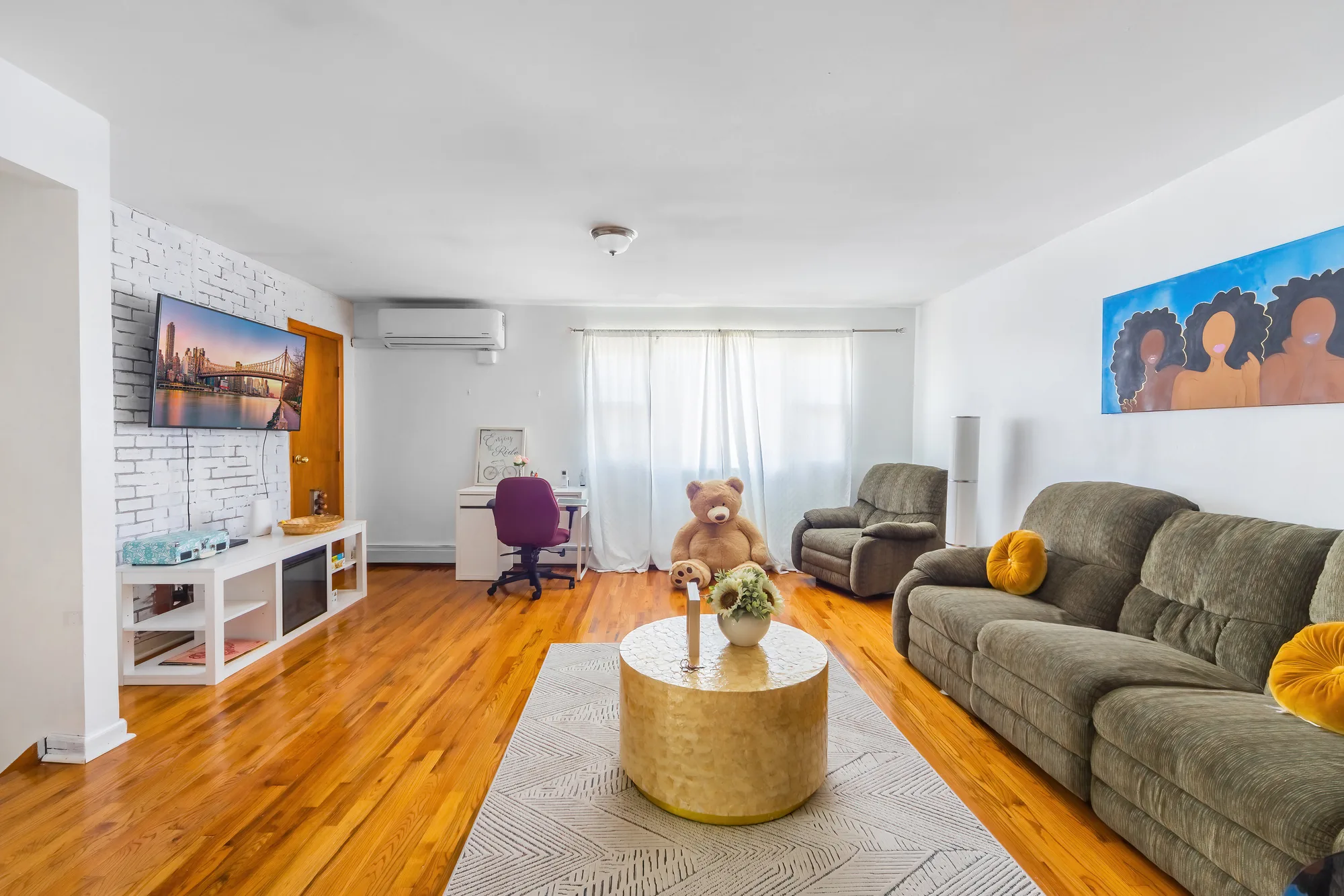 OpenDoors360 professional Airbnb photography of a furnished living room with hardwood floors and city wall art in a short-term rental, high quality images that make the airbnb listing stand out