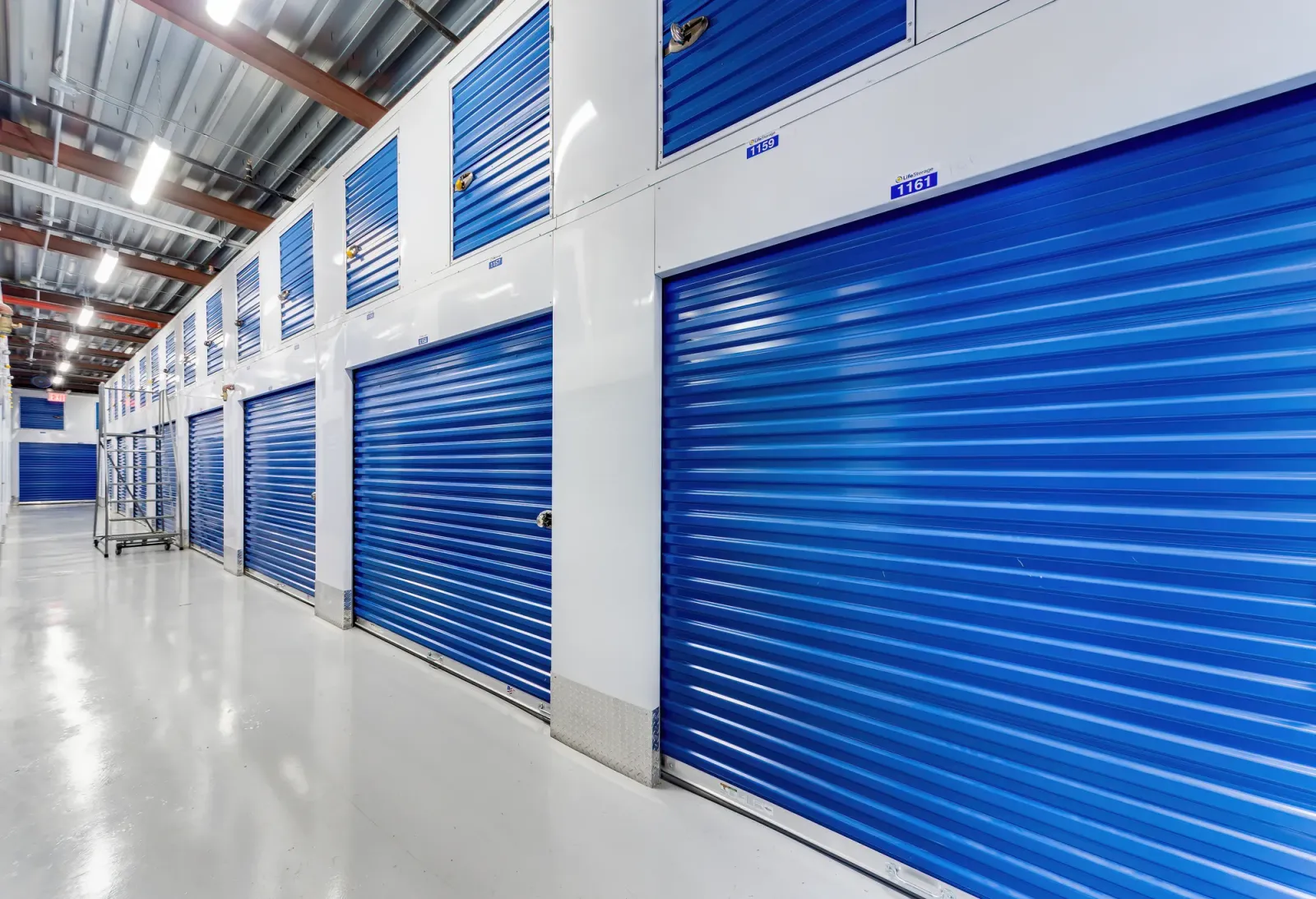 Interior row of blue roll-up storage unit doors at Life Storage in Bushwick, Brooklyn, New York, commercial real estate photography, by OpenDoors360