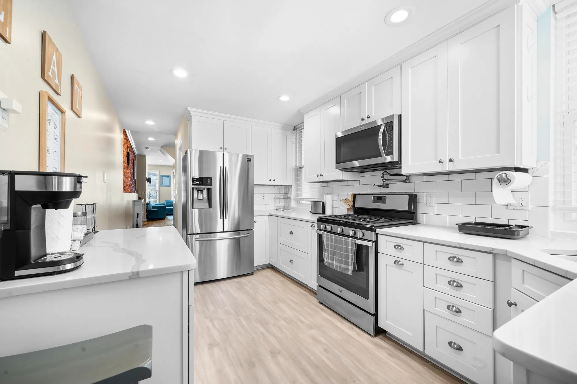 Galley kitchen with white shaker cabinets and subway tile in Baltimore, MD, by OpenDoors360