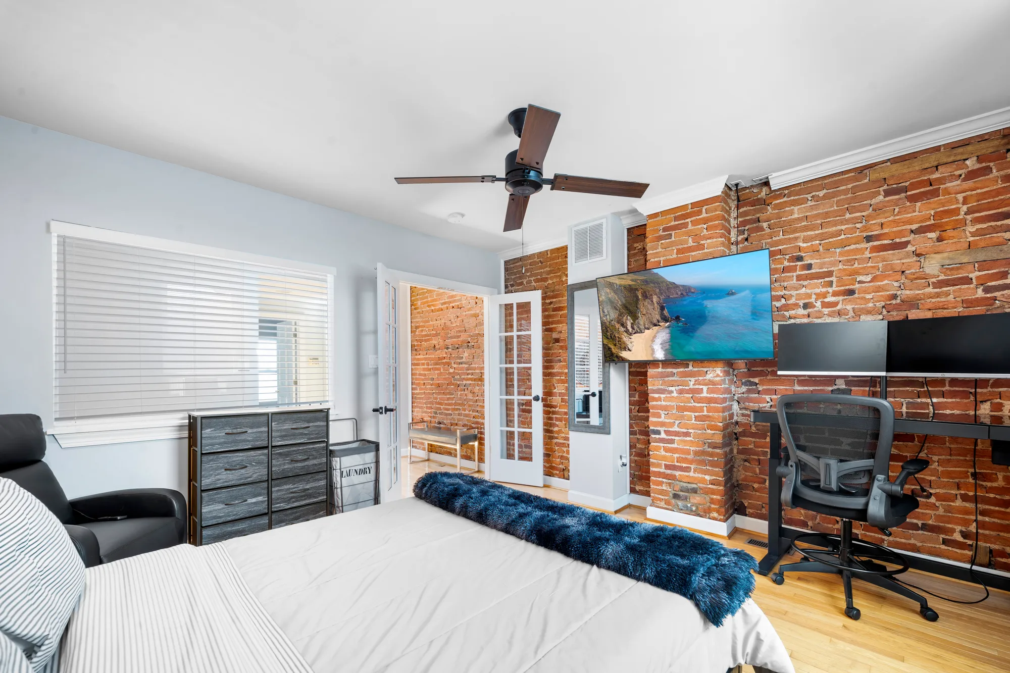 Bedroom with exposed brick, French doors and home office desk in Baltimore, MD, by OpenDoors360
