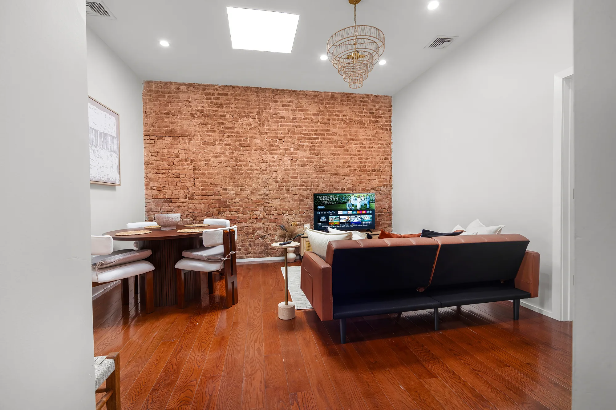 Exposed-brick living and dining room captured with HDR real estate photography in Brooklyn, New York