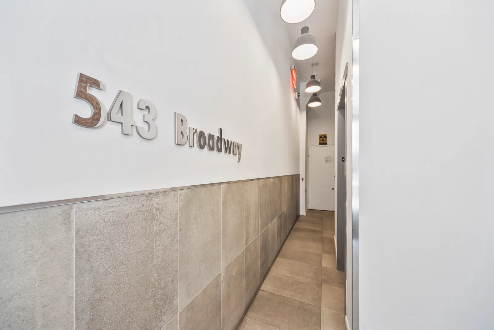 543 Broadway lettering on the lobby wall of a SoHo loft building, by OpenDoors360