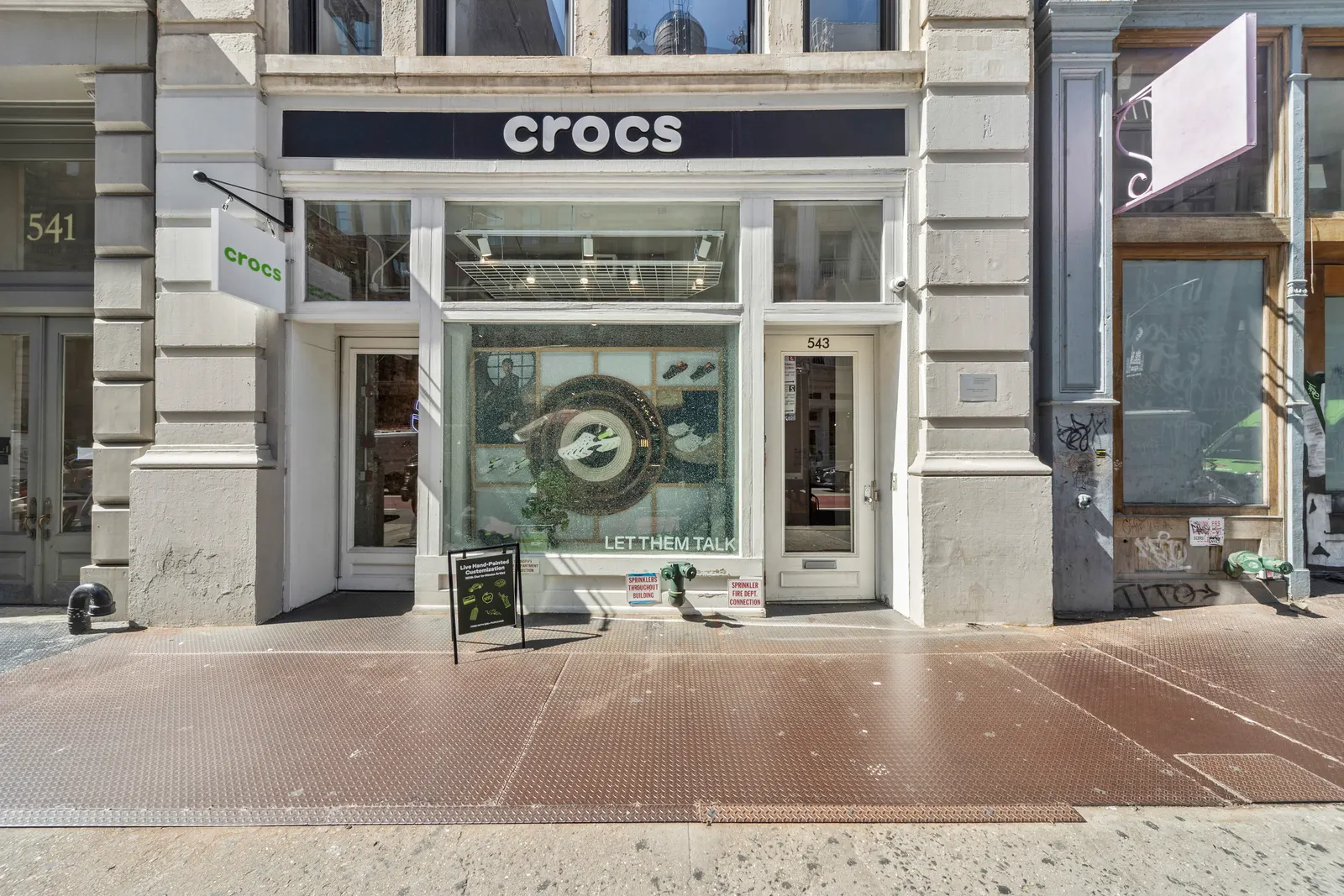 Cast-iron building front on Broadway in SoHo with a storefront at street level, by OpenDoors360
