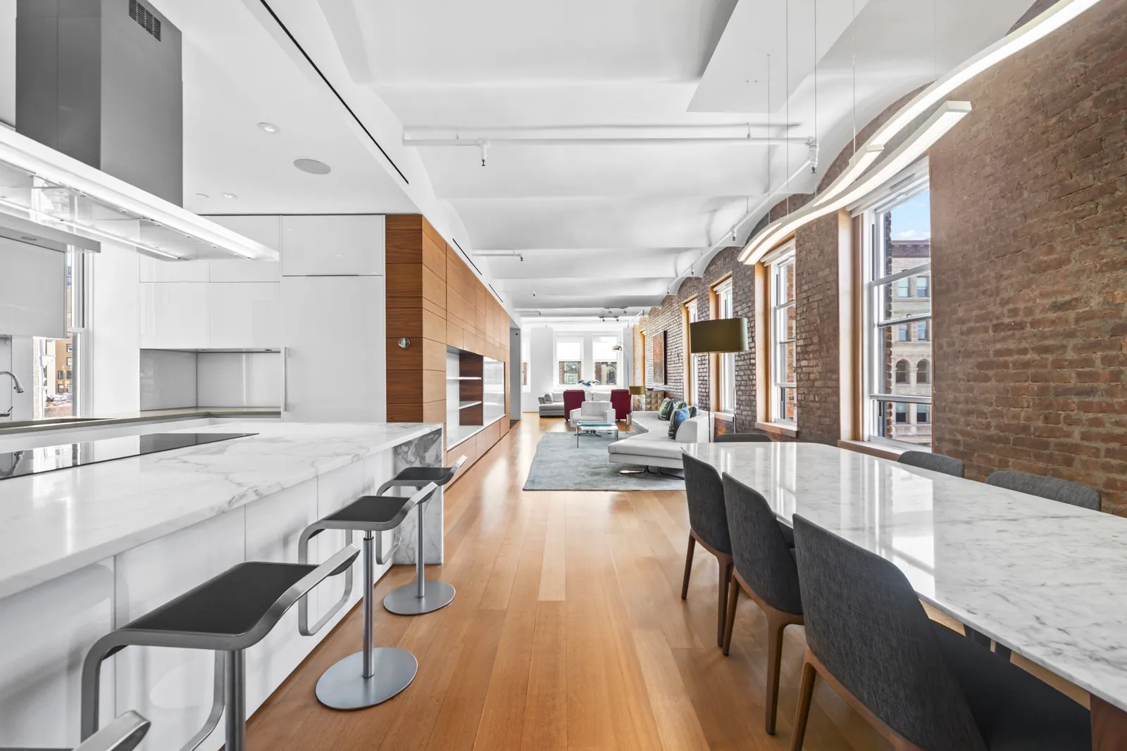 View from a marble kitchen island down the length of a SoHo loft to the living room, by OpenDoors360