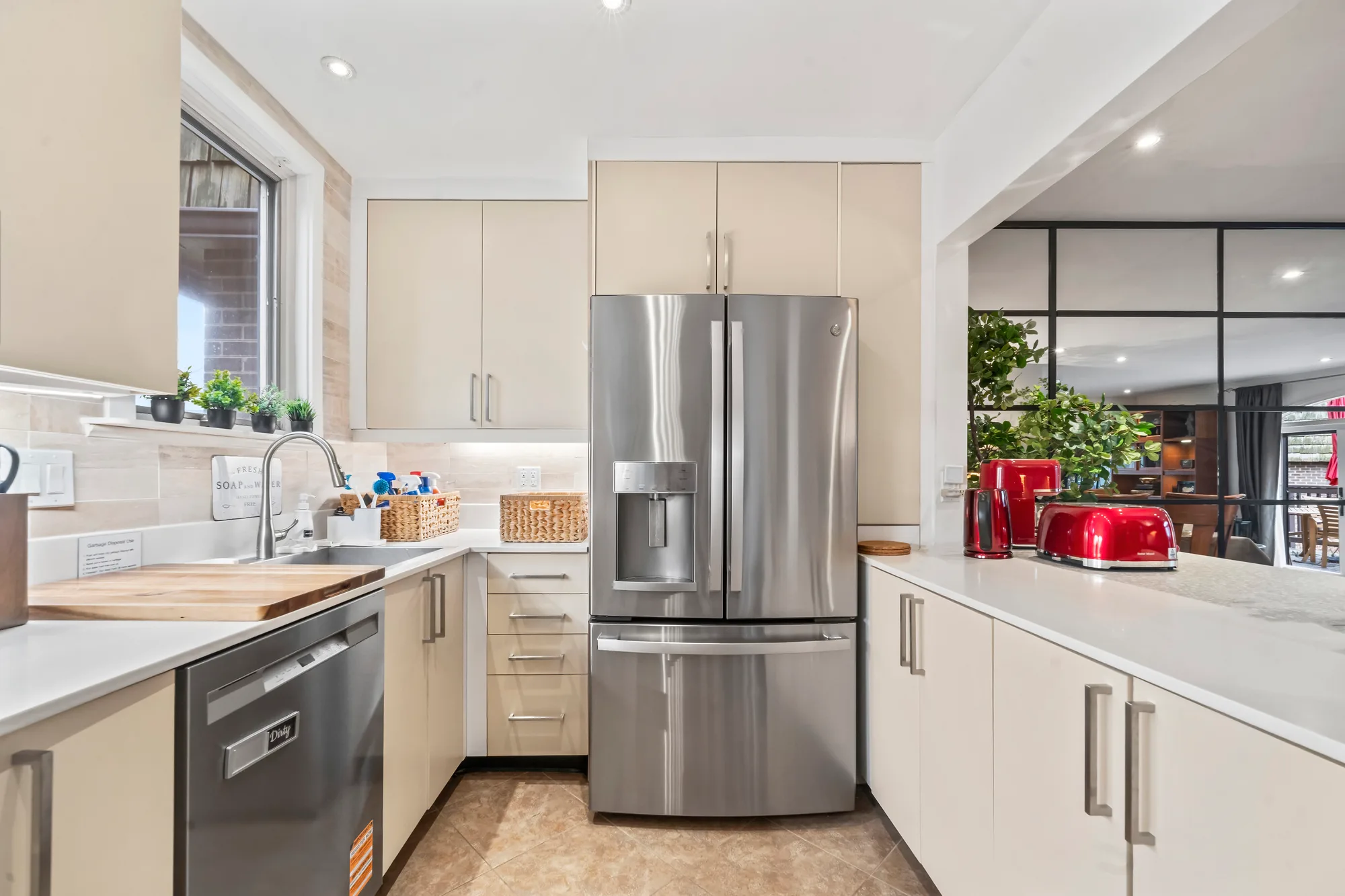 Kitchen with cream cabinets, stainless refrigerator and red toaster in Northern Virginia, by OpenDoors360