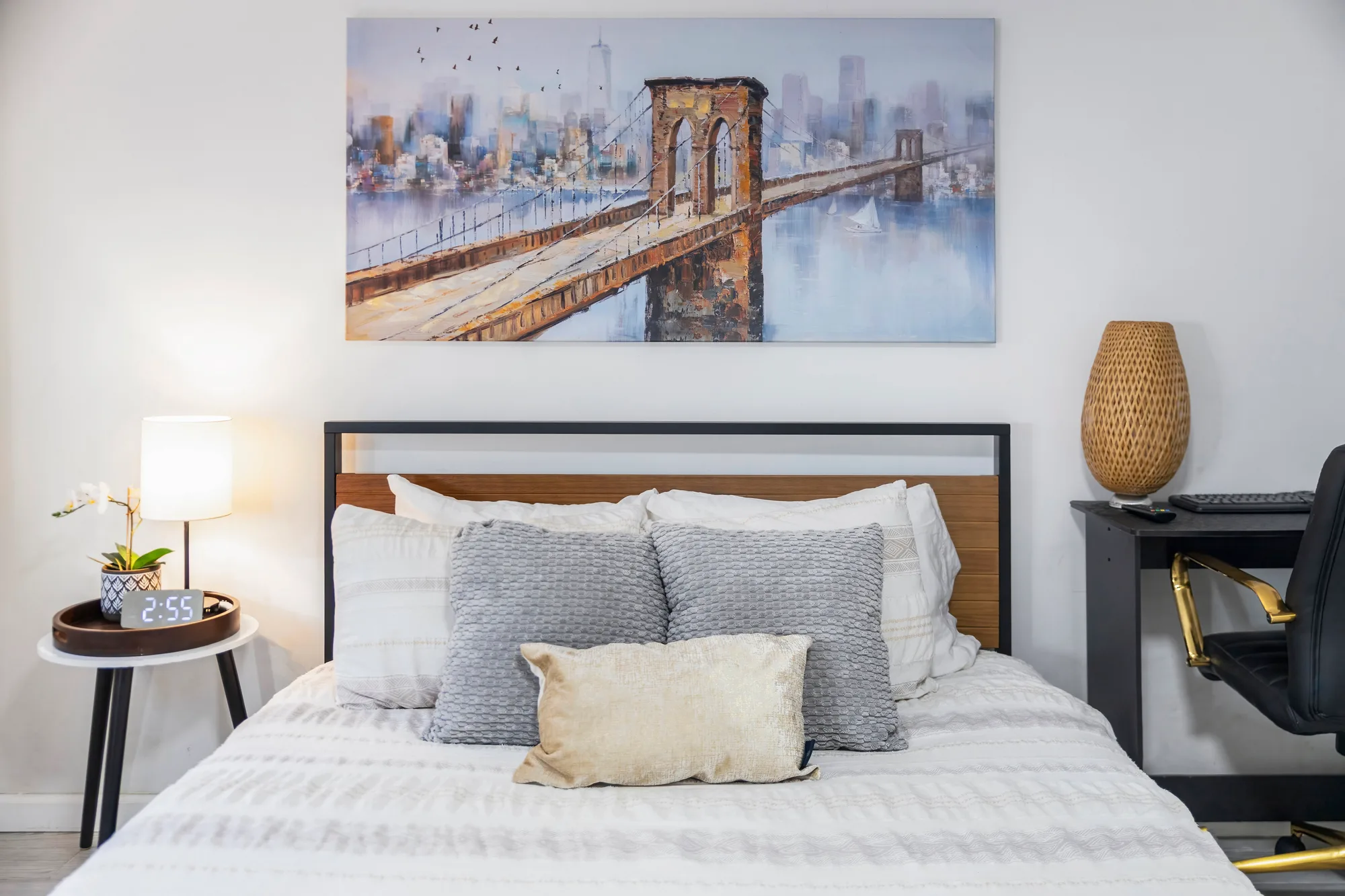 Bedroom with Brooklyn Bridge canvas above bed and gold desk chair, by OpenDoors360