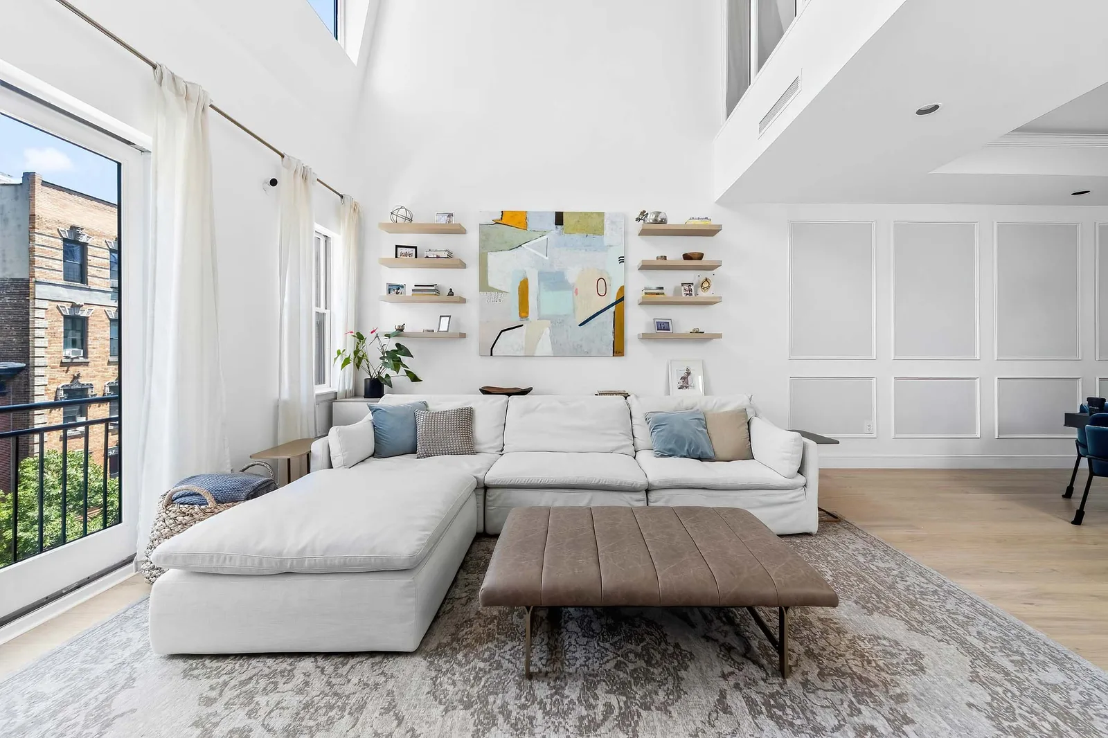 Double-height living room with floor-to-ceiling windows, HDR real estate photography on Staten Island shot by a professional photographer for a single-family listing
