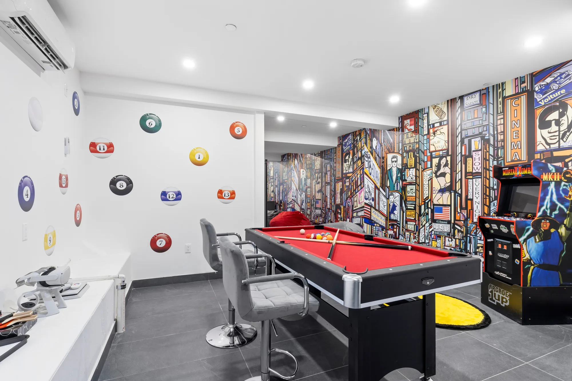 Game room with a pool table and arcade machine, professional photography of the amenities for a short-term rental Airbnb listing in New York City