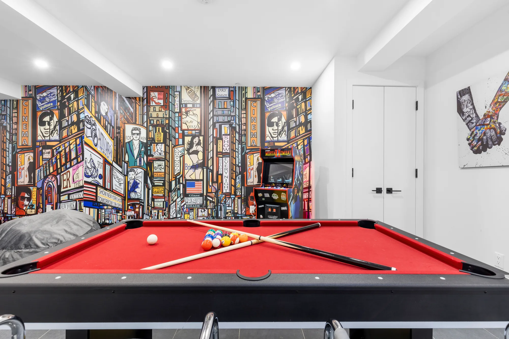 Game room with New York City skyline mural, real estate photography that captures the focus and life of an apartment for buyers and realtors