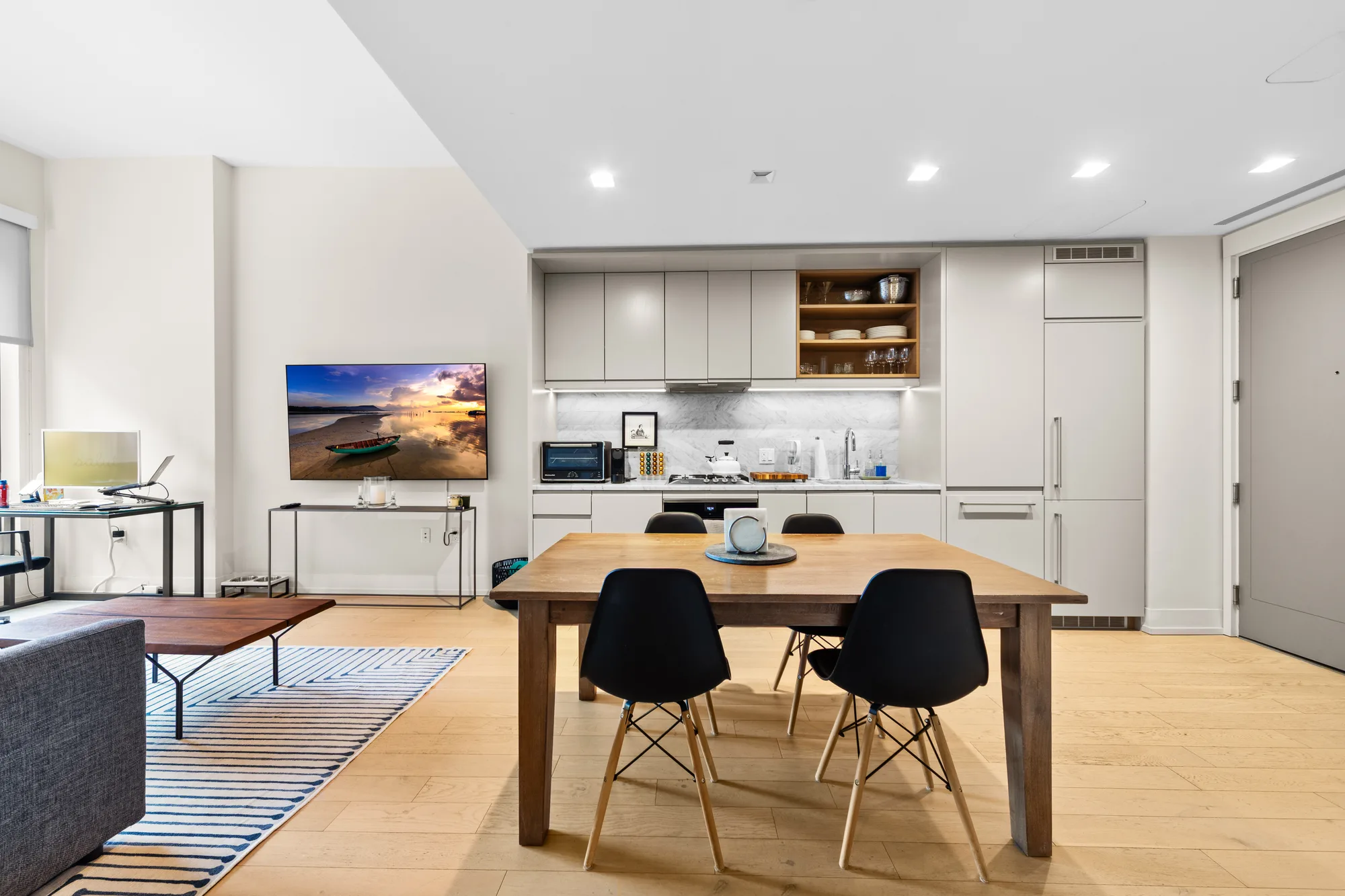 Open-plan living and dining room in a New York City condo listing, HDR real estate photography by OpenDoors360