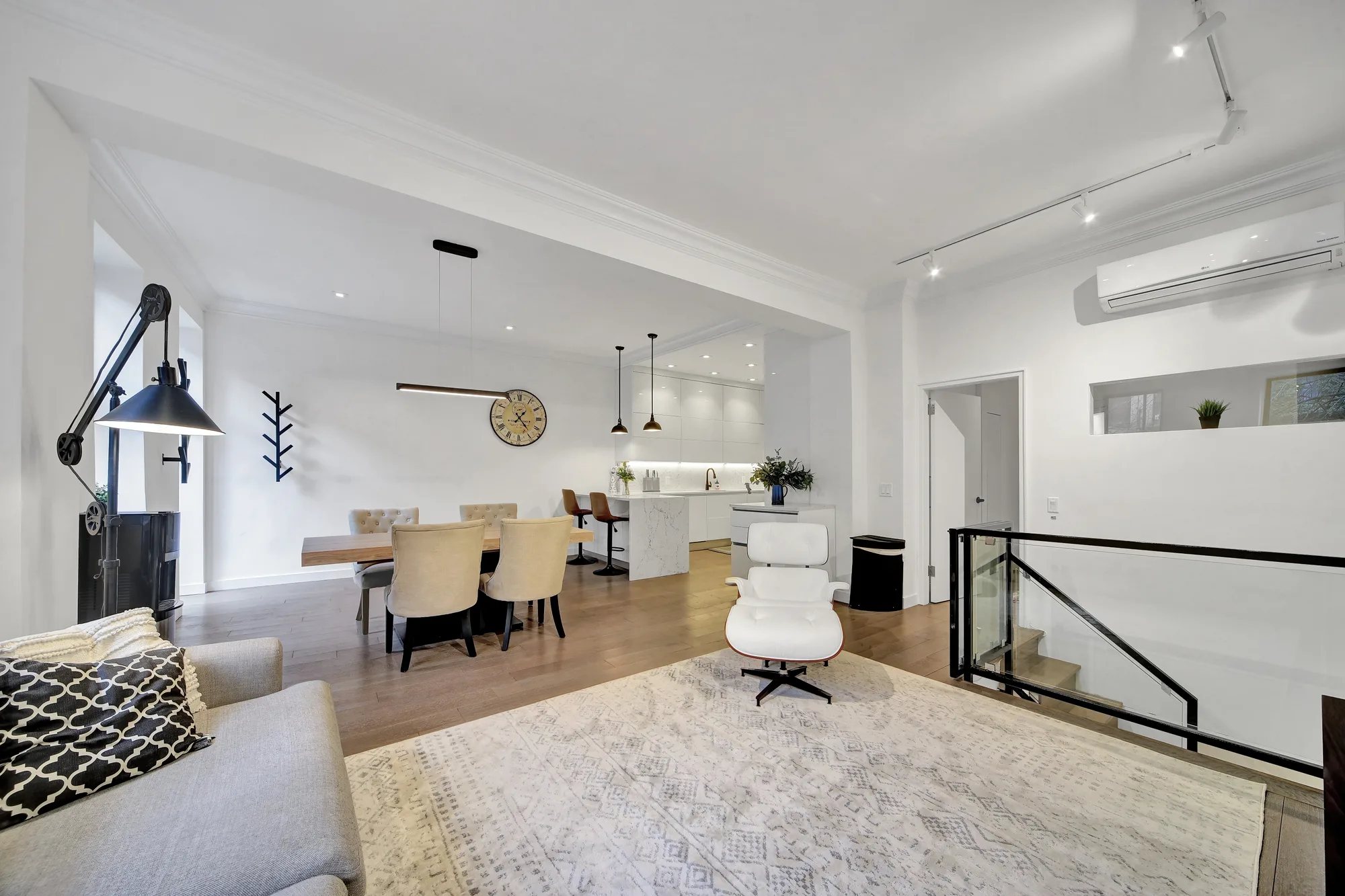 Open-plan living and dining room real estate photography for a New York City loft listing, shot in five-stage HDR with corrected vertical lines
