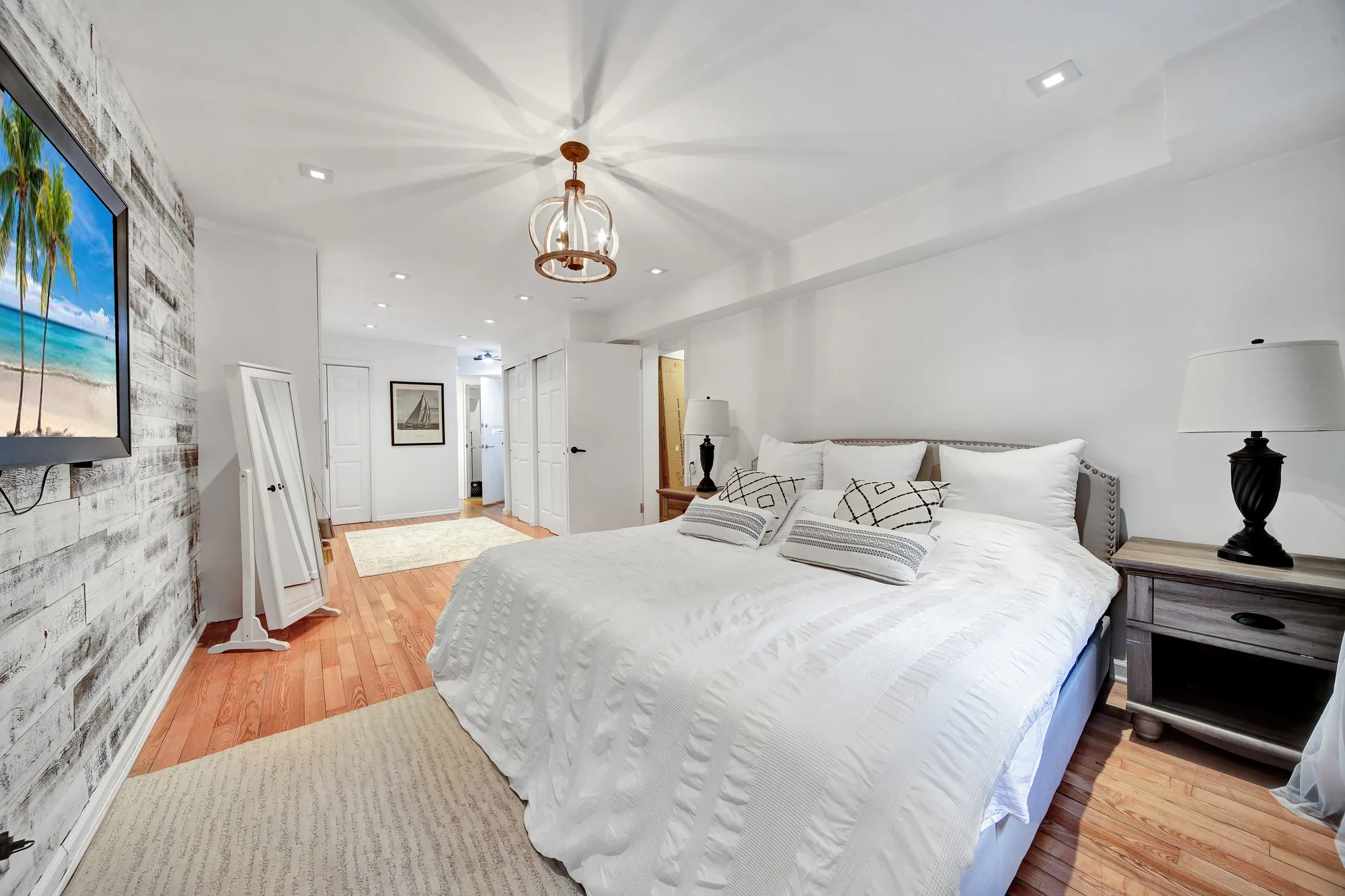 Bright primary bedroom with a chandelier shot for a New York City listing by an OpenDoors360 real estate photographer