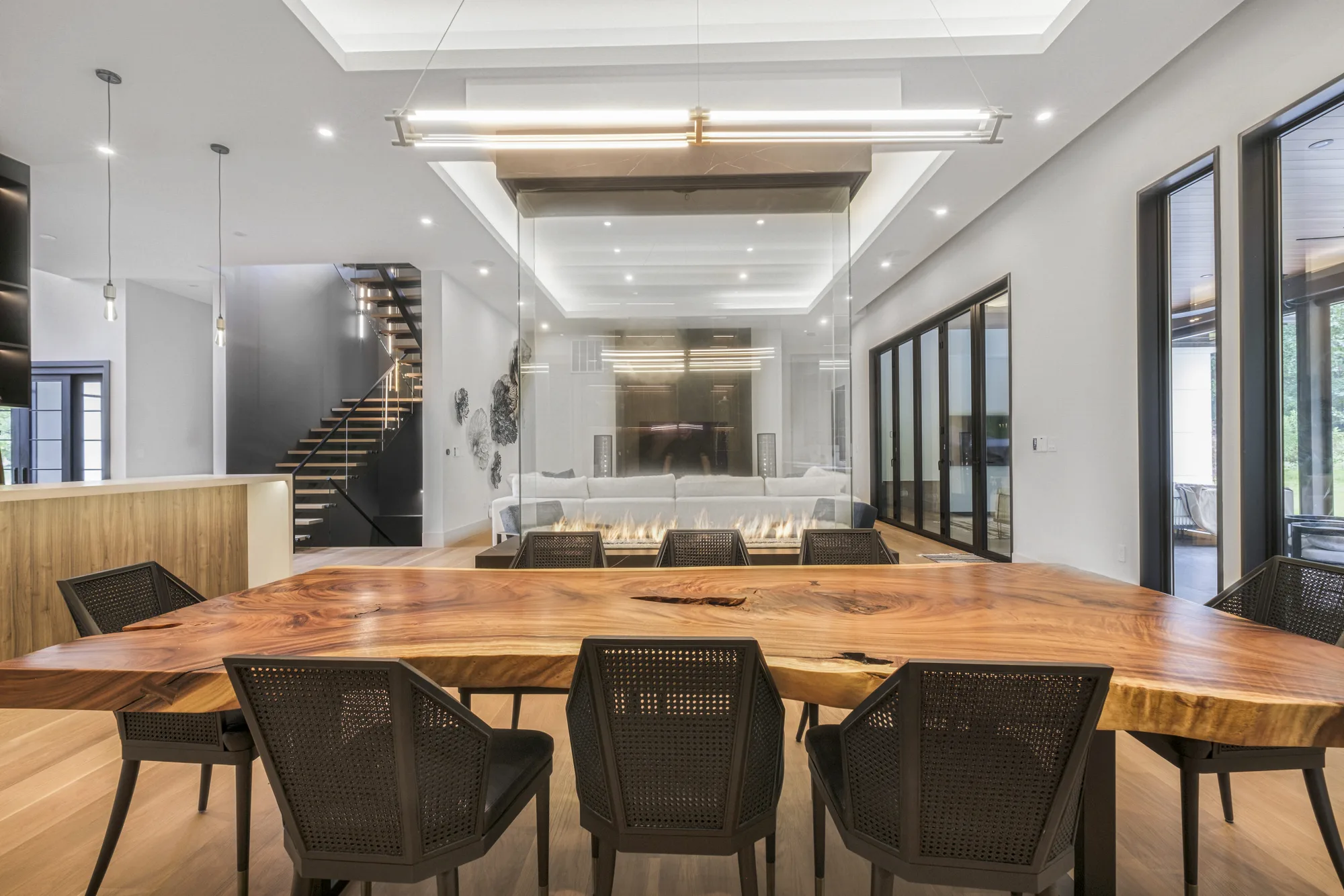 Live-edge dining table and modern staircase, interior real estate photography for a New York City property suited to a 360 virtual tour