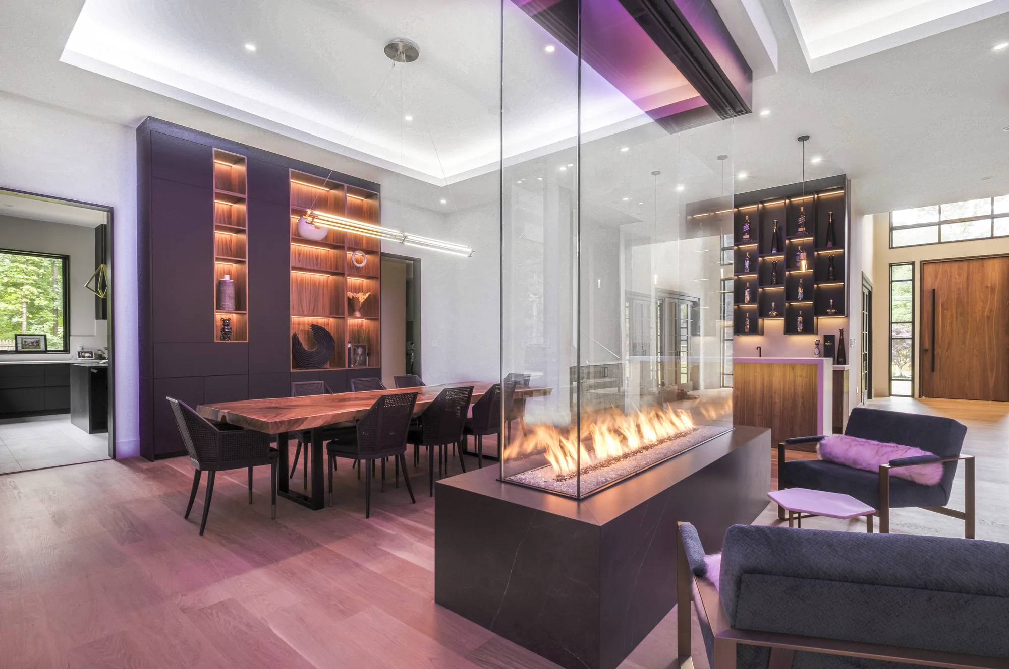 Open-plan dining and lounge with a linear fireplace captured on a real estate photo shoot in New York City