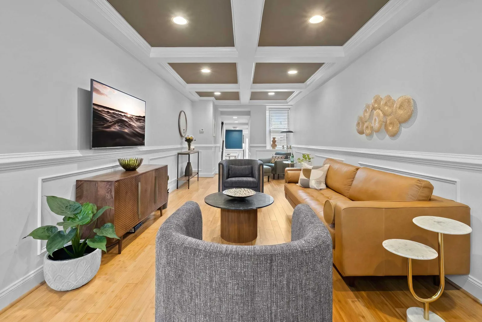 Coffered-ceiling living room with leather sofa, residential real estate photography for a New York City listing shot in HDR
