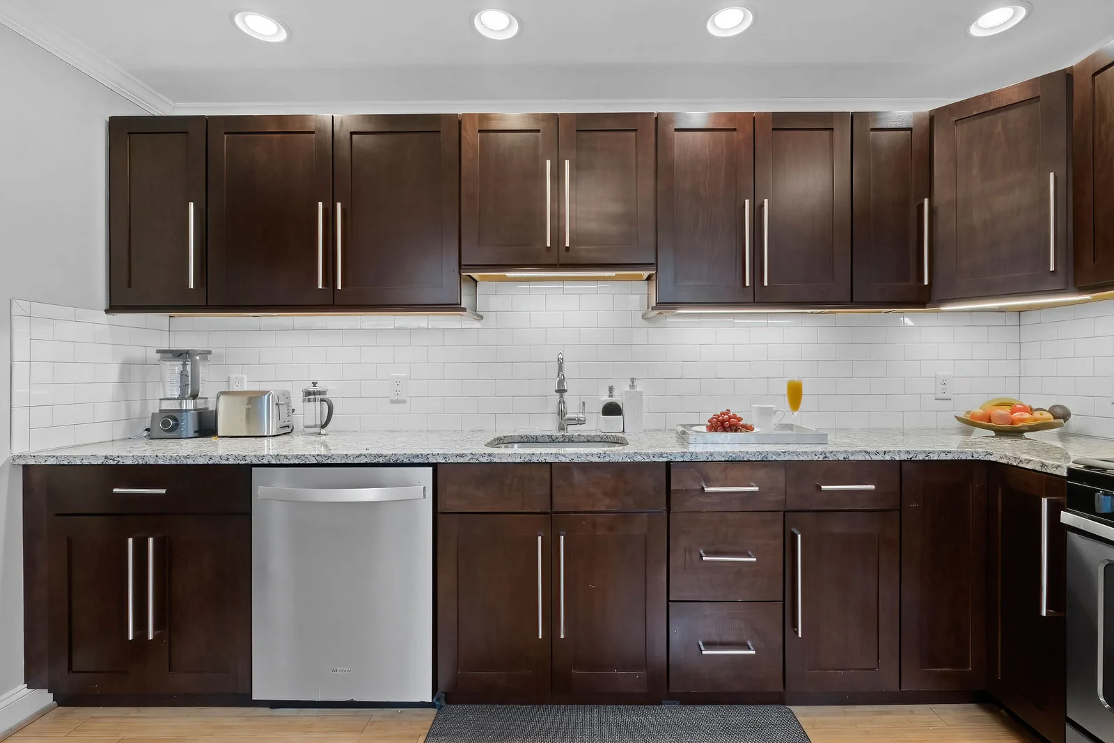 Clean kitchen with stone counters in a short-term rental, professional photographers capture the amenities for an Airbnb listing in New York City