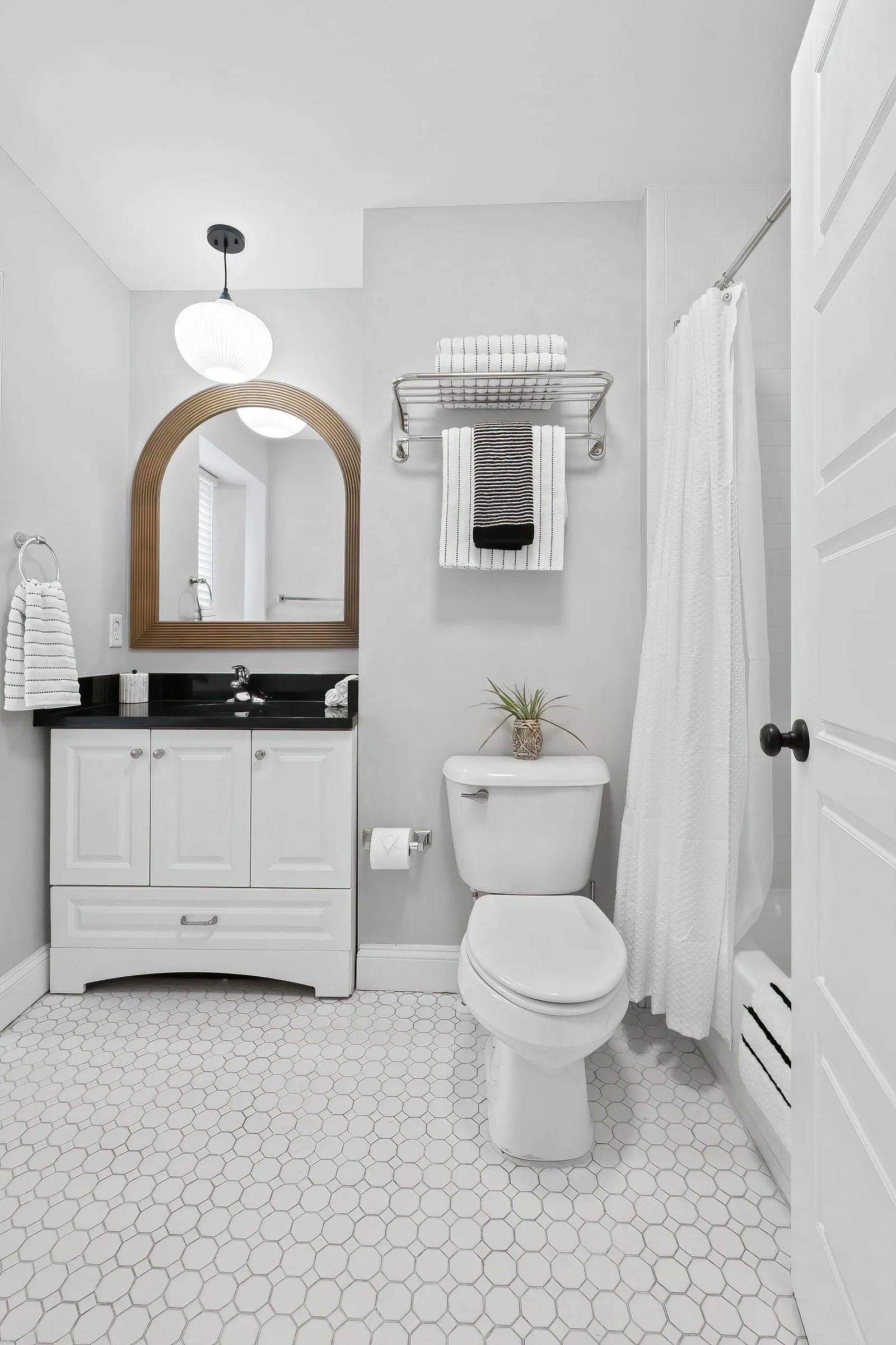 Open-plan studio short term rental with kitchen and in-unit laundry amenities, short term rental photography of a vacation rental in New York City