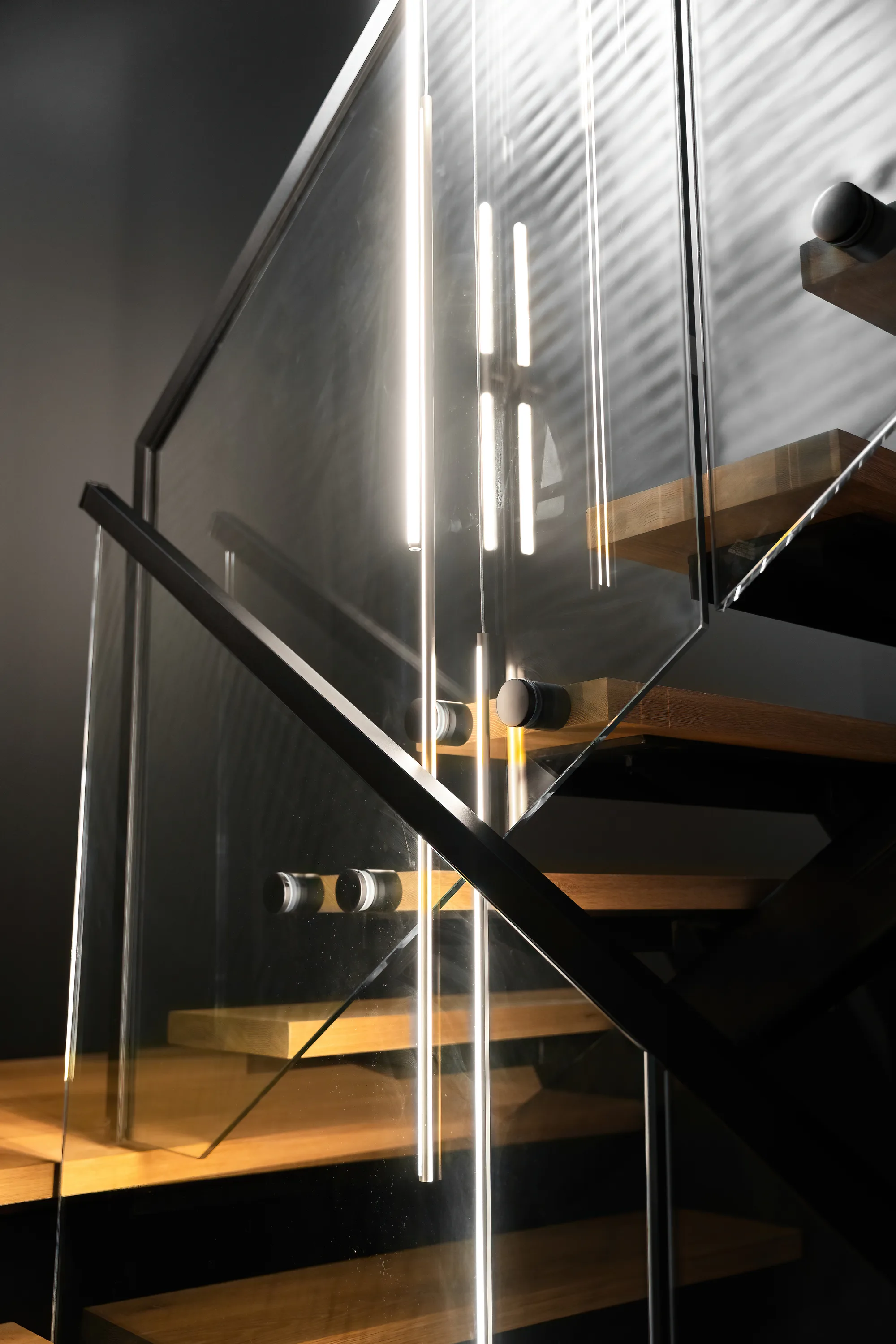 Backlit glass-railed staircase with floating wood treads in Clifton, VA home, by OpenDoors360
