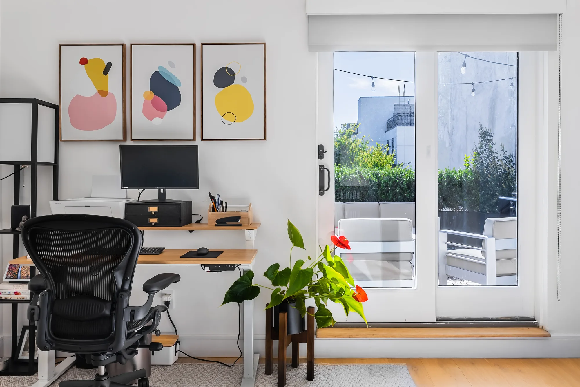 Home office workspace with desk and terrace doors, interior real estate photography for a Brooklyn New York City apartment