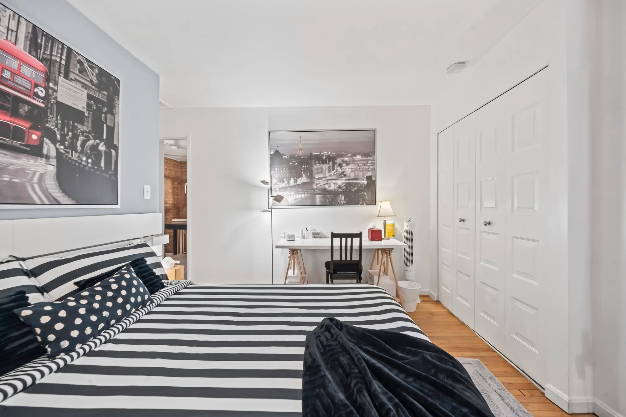 Furnished bedroom with travel artwork shot for real estate virtual tours in New York City, navigable room to room