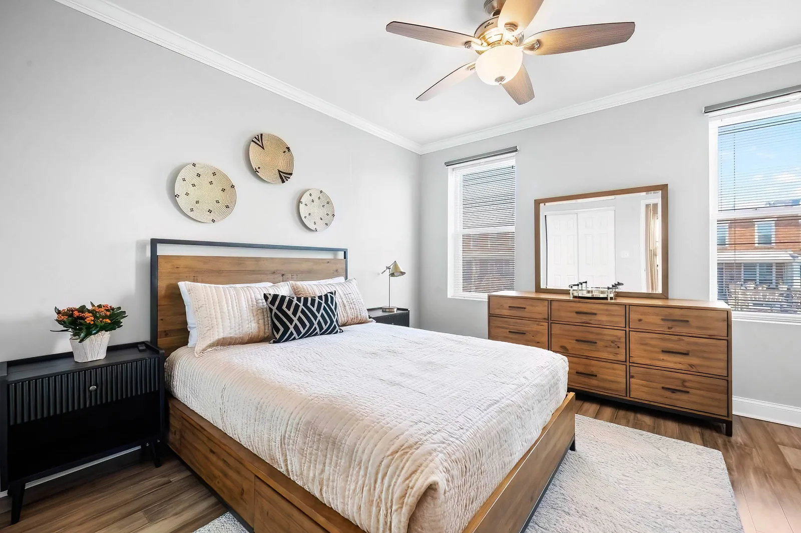 Warm bedroom with a wood dresser photographed for a Baltimore real estate listing by OpenDoors360