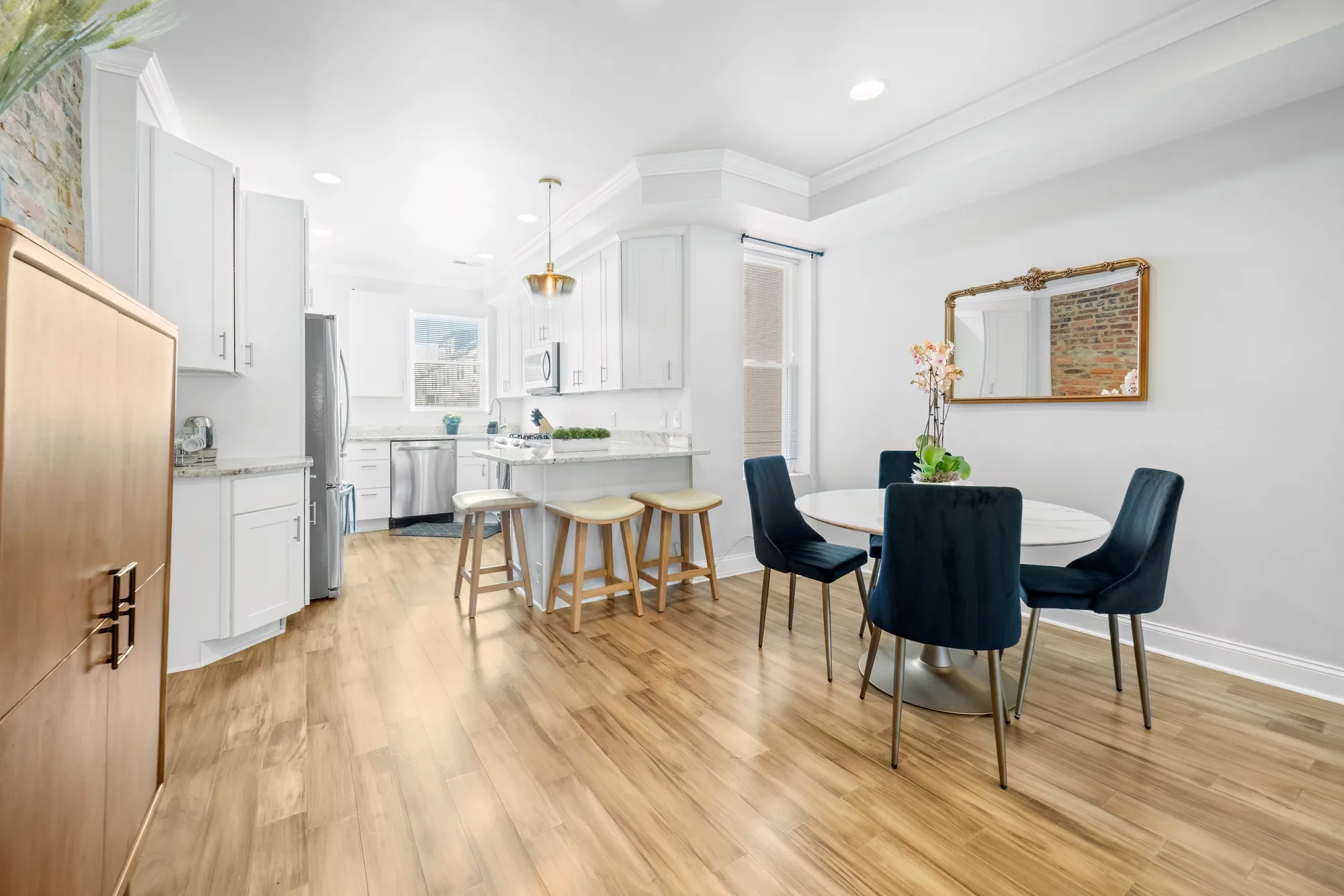 Open kitchen and dining area in a New York City short term rental, professional photography of high quality images of the amenities for an Airbnb and Vrbo listing